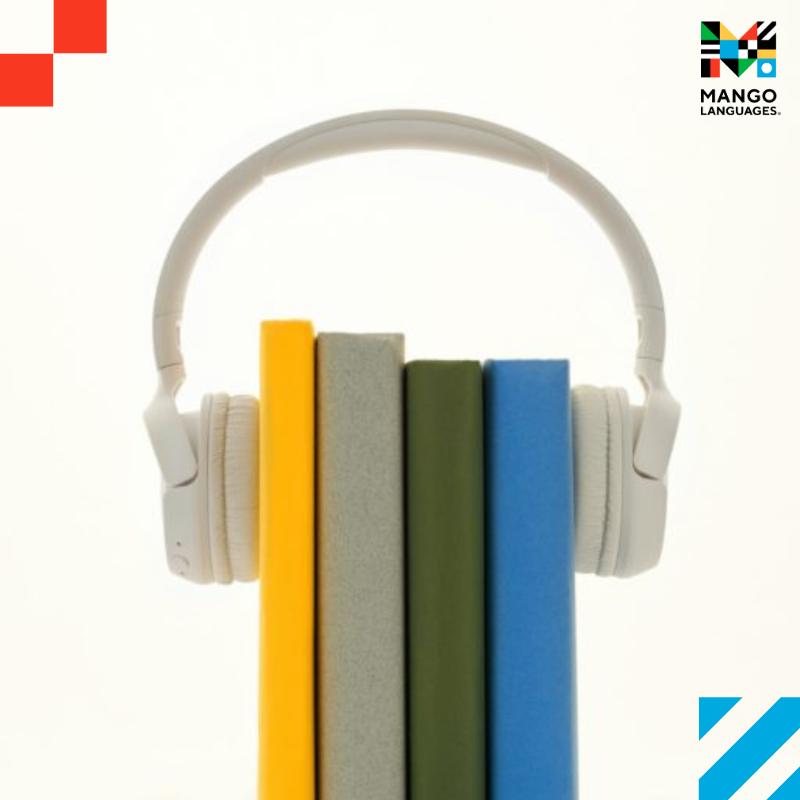 Four books (yellow, gray, green, and blue) bound together by a pair of headphones