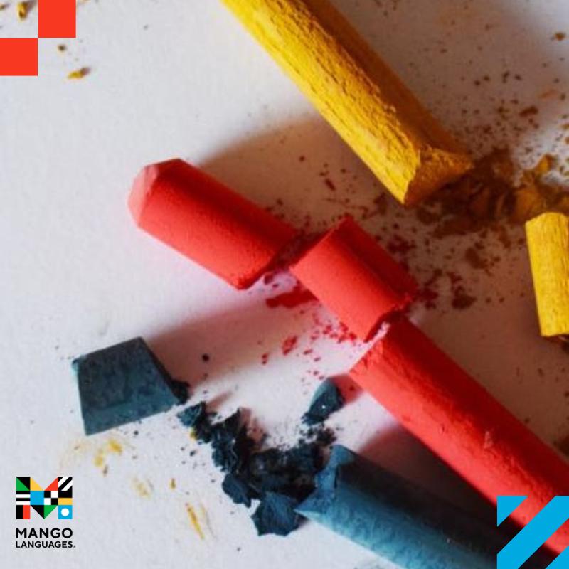 Three crayons, yellow, red and blue on a piece of paper