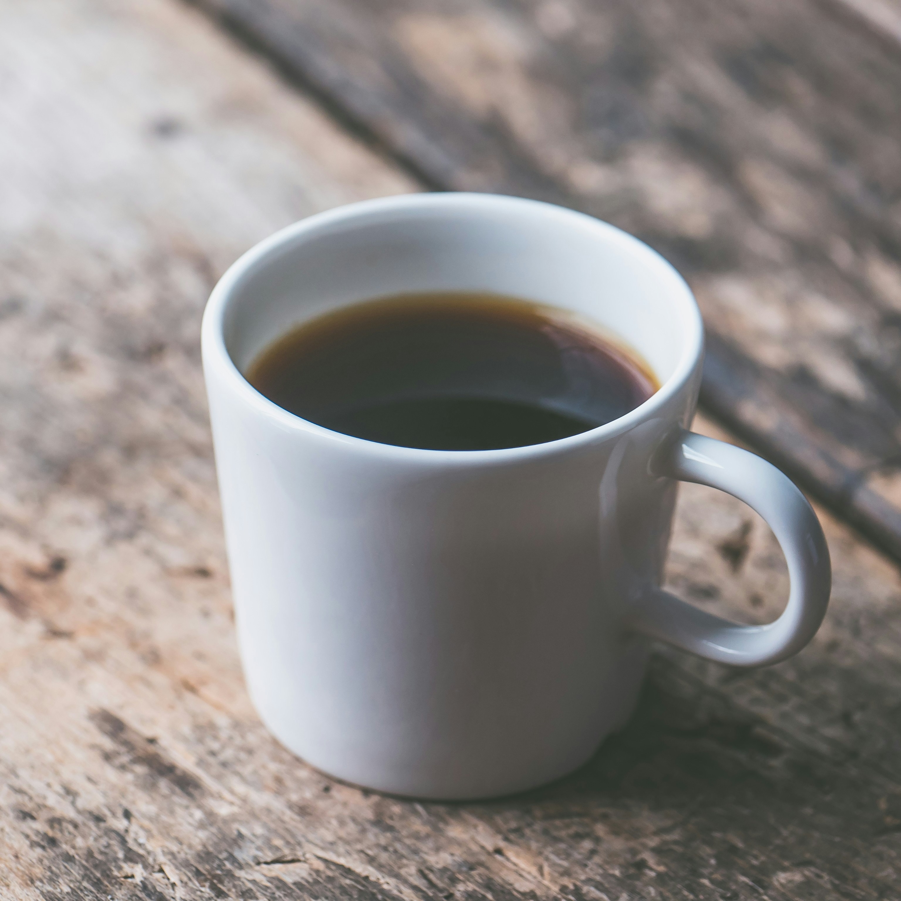 A cup of coffee on a rustic wood table