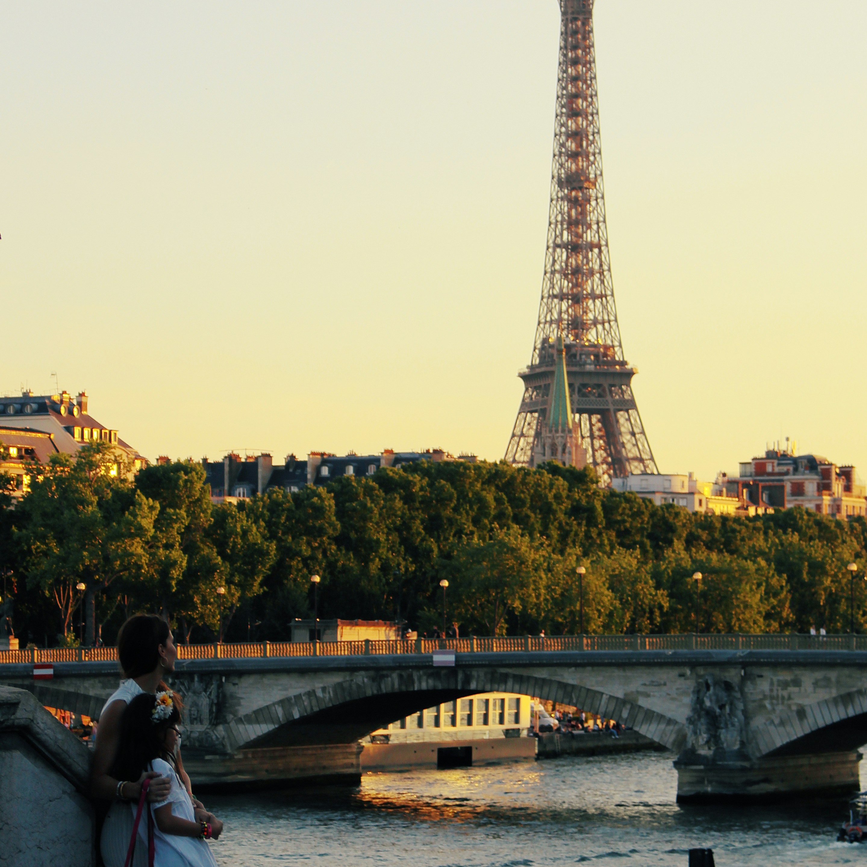 A sunset view looking across a river (and a bridge) toward the Eiffel Tower