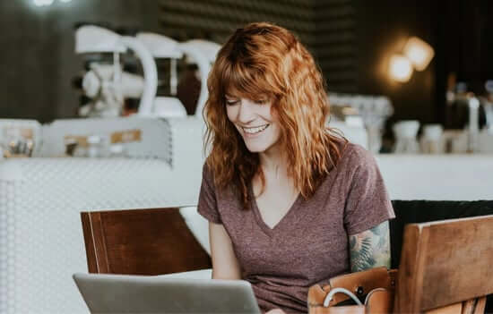 A girl on her laptop at a café