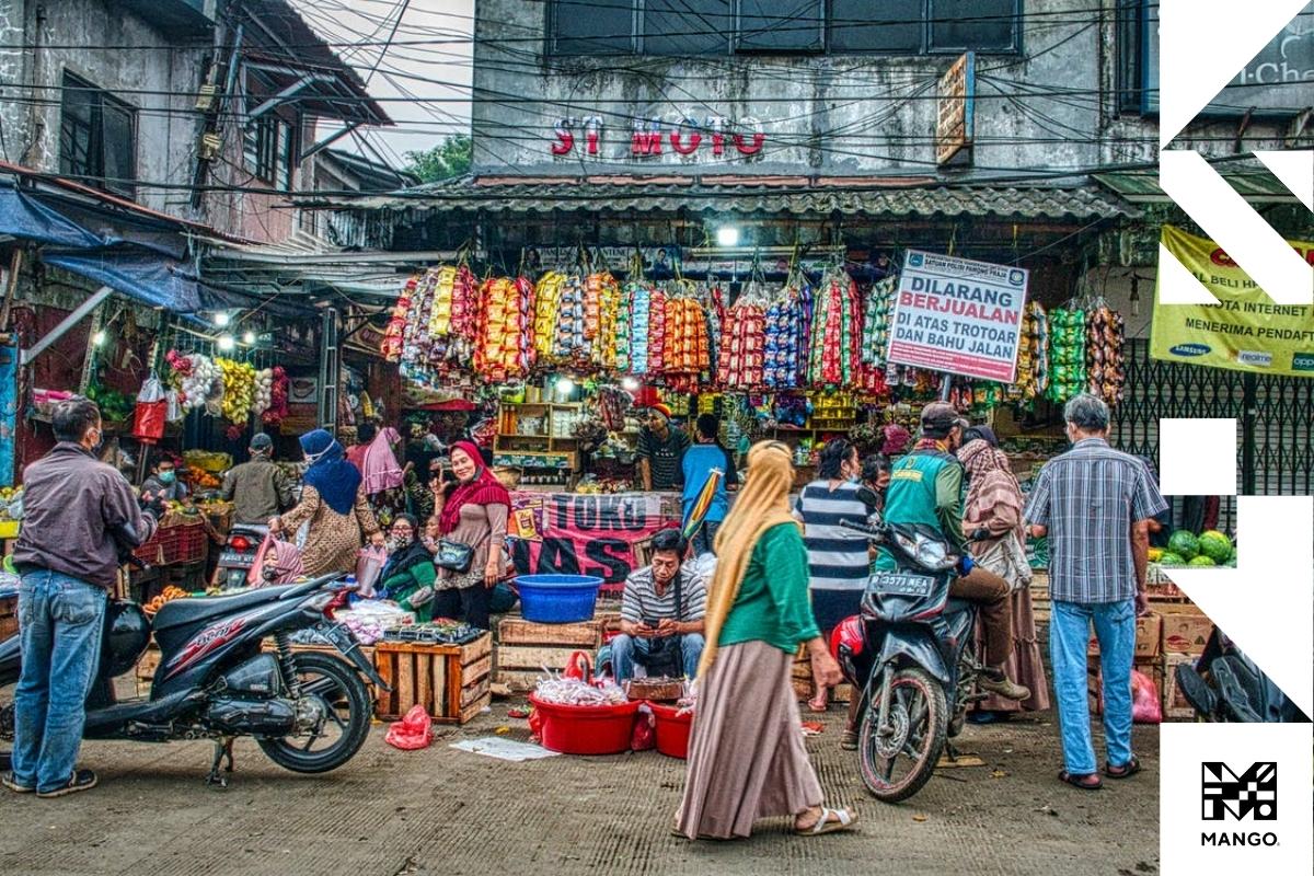 A very busy street market selling all sorts of different produce, clothes and more