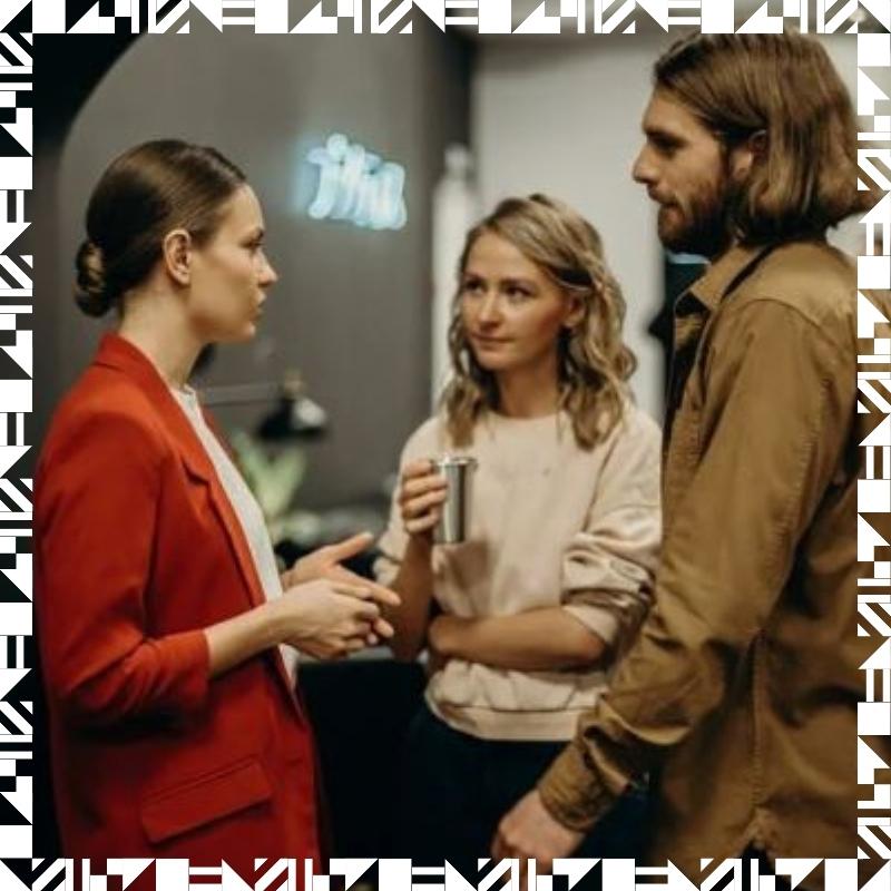 Three people deep in conversation in a living room